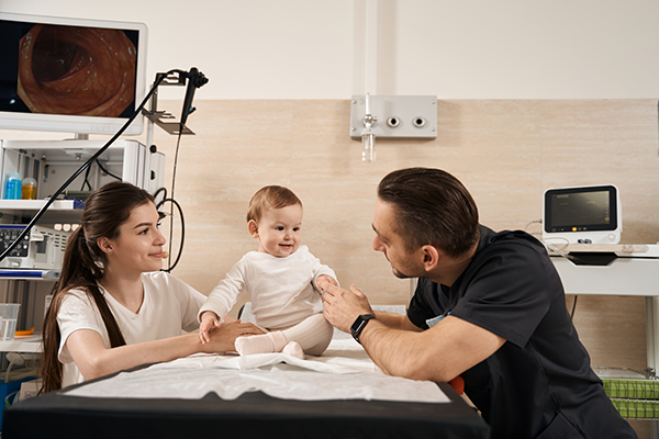 baby sitting on table with parents